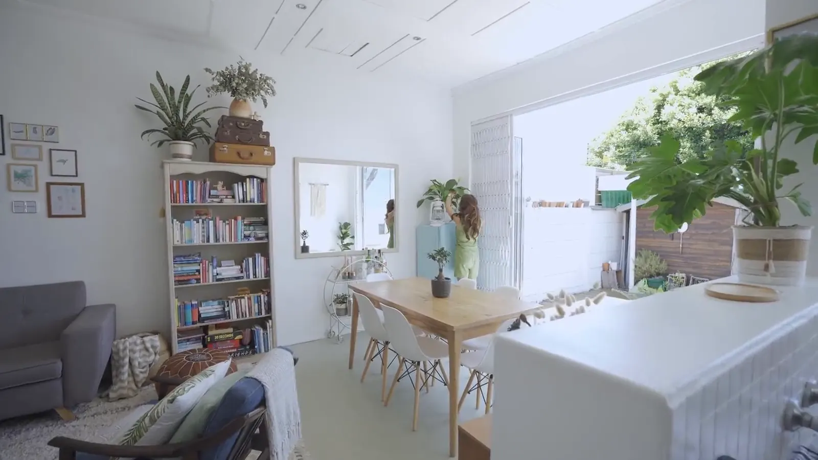 A bright, plant-filled living and dining room in a well-managed rental home